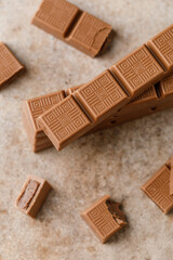 Chocolate bar with filling on brown background. Stack of dark and milk chocolate. Chocolate concept