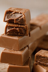 Chocolate bar with filling on brown background. Stack of dark and milk chocolate. Chocolate concept
