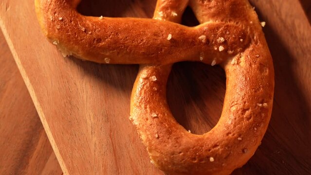 Gluten free pastry 4k video tilt camera move. Close up view of a fresh got out of over gluten free pretzel made of different types of flour without wheat. Healthy food.