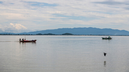 Fototapeta na wymiar Fishermen sail boats with flying bird in Kung Krabaen, Chanthaburi