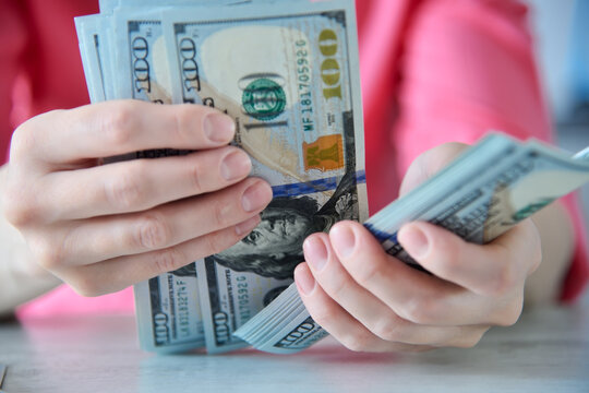 Close up of woman hands counting dollars