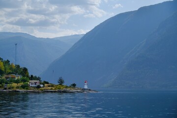 Coast with a lighthouse in  Hjelmeland. Durign trip by ferry from Nesvik to  in Norway.