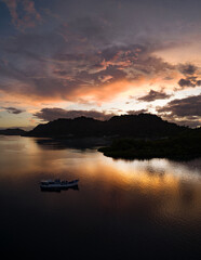 The last light of day illuminates clouds drifting above remote islands in the Solomon Islands. This beautiful country is home to spectacular marine biodiversity and many historic WWII sites.