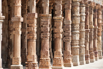 Row of pillars with bas relief carvings in the complex of Qutb Minar, Delhi. Architectural columns...