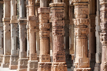 Row of pillars with bas relief carvings in the complex of Qutb Minar, Delhi. Architectural columns...