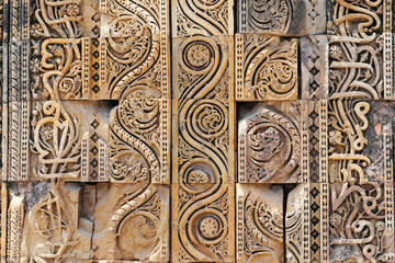 Floral Motfis decoration in the wall of Qutb Minar complex at New Delhi, India. Relief carving at the old monument. Unesco heritage site at Delhi.