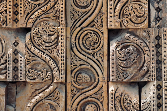 Floral Motfis decoration in the wall of Qutb Minar complex at New Delhi, India. Relief carving at the old monument. Unesco heritage site at Delhi.