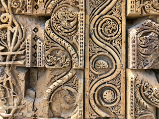 Floral Motfis decoration in the wall of Qutb Minar complex at New Delhi, India. Relief carving at the old monument. Unesco heritage site at Delhi.