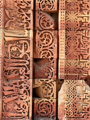 Floral Motfis decoration in the wall of Qutb Minar complex at New Delhi, India. Relief carving at the old monument. Unesco heritage site at Delhi.