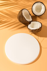 Tropical product presentation scene made with white circle podium and coconuts. Vertical photography.