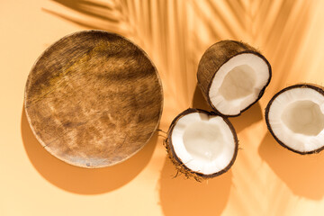 Tropical product presentation scene made with circle wooden plate and coconuts.