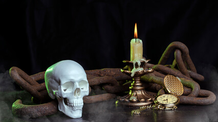 A magic skull on a wooden table, a burning candle in chains and a clock that has stopped time.