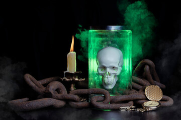 Glowing magic skull in a jar on a wooden table chained. Smoke comes from a candle, an old clock has stopped time.