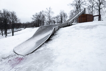 fragment of a children's slide in the park in winter
