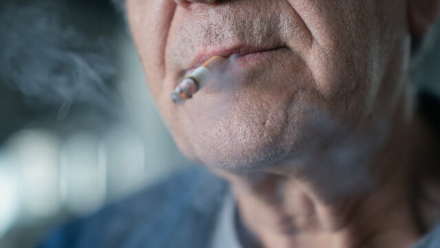 Old Man Smoking A Cigarette