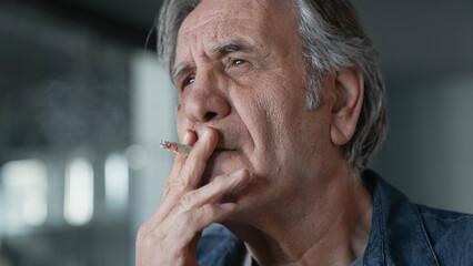 Old man smoking a cigarette - 559529065