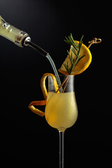 Limoncello is poured into a glass.