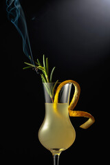 Fototapeta Limoncello garnished with a steaming rosemary branch. obraz