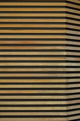 Golden Oak Planking on a Black Stucco Wall.