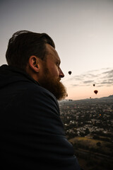 Man looking out over Mexico City and Pyramids riding in a hot air baloon