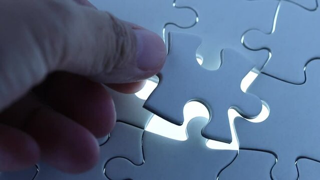 last piece of jigsaw filling by hand, concept of teamwork, leader, success and solution solving