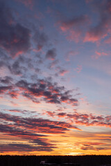Sunset sky. Yellow sky with purple clouds