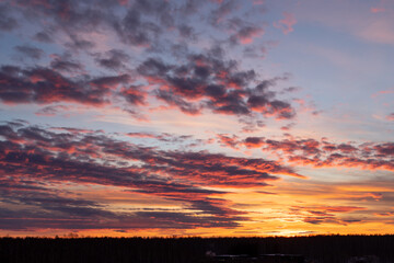 Sunset sky. Yellow sky with purple clouds