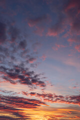 Sunset sky. Yellow sky with purple clouds