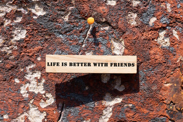 LIFE IS BETTER WITH FRIENDS was written on the wooden surface. Wooden Concept