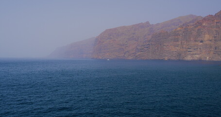 Sandstorm Calima in Atlantic Ocean Los gigantes Cliffs. Puerto de Santiago. Canary Islands. African...