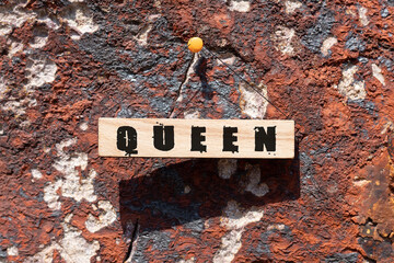 Queen was written on the wooden surface. Wooden Concept