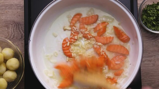 Saut&eacute; carrots and onions until translucent in one bowl