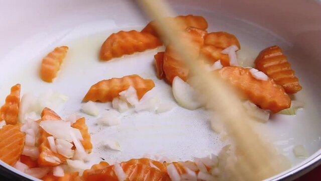 Saut&eacute; carrots and onions until translucent in one bowl