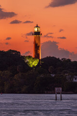 View to the Jupiter lighthouse on the north side of the Jupiter Inlet at sunset. © elena_suvorova