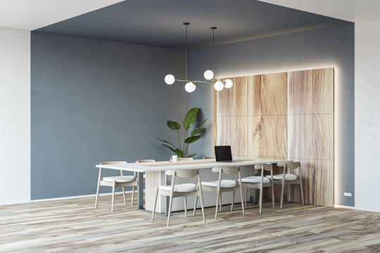 Stylish Conference Room With Eco Decoration, Perspective View On Modern Laptop On Light Meeting Table Surrounded By Chairs On Wooden Floor And Grey Wall Background. 3D Rendering