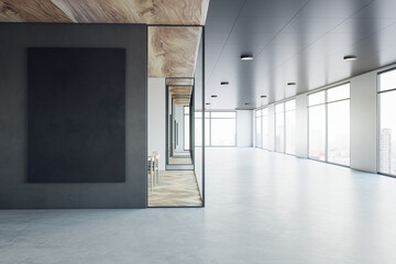 Front view on black poster on dark wall background in sunlit modern interior design office with concrete floor, meeting room with wooden decoration and city view from windows. 3D rendering, mock up