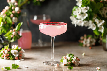 Spring and summer refreshing pink cocktail with apple blossom on light background. Pink summer cocktail - Powered by Adobe