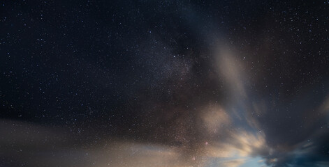 Beautiful long exposure night sky with clouds and stars . Starry sky background.