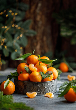 Christmas tangerines in metal box with christmas decorations on dark background. Christmas concept 