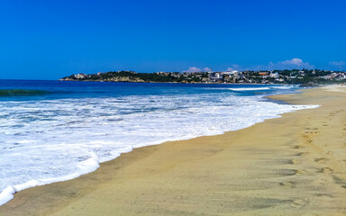 Sun beach people waves and boats in Puerto Escondido Mexico.