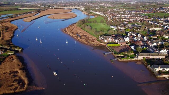 Aerial shot flying over wetlands and estuary of River Exe at Topsham in Devon, UK