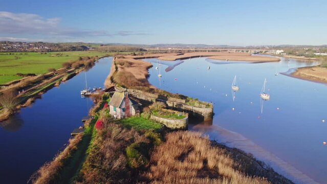 Drone view flying over river Exe and lock with boats towards Topsham, Devon. UK