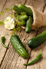 Fresh cucumbers in a bag on a wooden surface. Organic vegetables. Harvest of cucumbers.