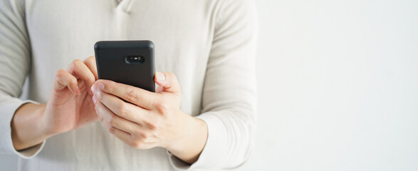 close up manager businessman hold smartphone to checking stock market exchange or read news on online website at office room in relax time for lifestyle business concept