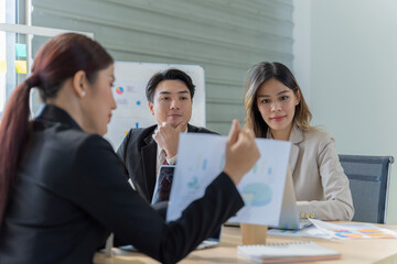 A group of young Asian businessmen Talking and planning work happily and have fun. at the company's office