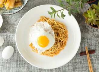 Mushroom Sizzling Noodles with sunny Egg served in dish isolated on napkin top view on table taiwan food