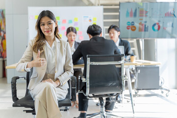 Fototapeta premium A group of young Asian businessmen Talking and planning work happily and have fun. at the company's office