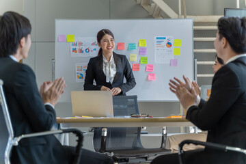 A group of young Asian businessmen Talking and planning work happily and have fun. at the company's office