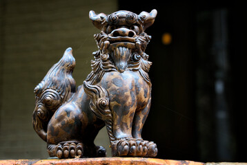 Kyoto, Japan, Asia - Guardian lion statue - Shisa at entrance to house, people place pairs of shisa at gates to protect their houses, left shisa with closed mouth keeps good spirits in