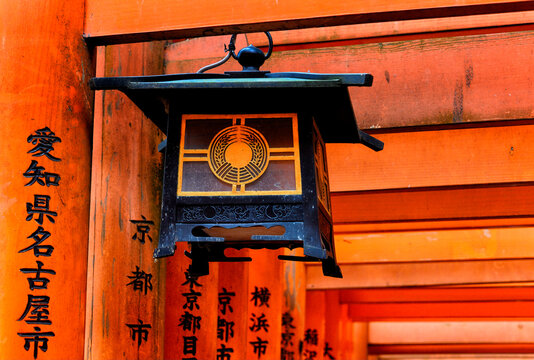 Fushimi, Kyoto, Kansai Region, Japan, Asia, Lantern hanging in Torii gates entrance leading to Fushimi Inari-taisha Shrine, head shrine of Inari located in Fushimi-ku